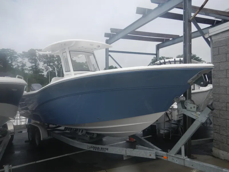 Slide: The Image of 2025 Sea Fox 268 Commander boat on a trailer in a marina. - 2