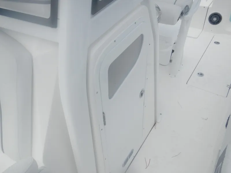Slide: The Image of 2025 Sea Fox 268 Commander boat interior, featuring a white cabin door and deck. - 23