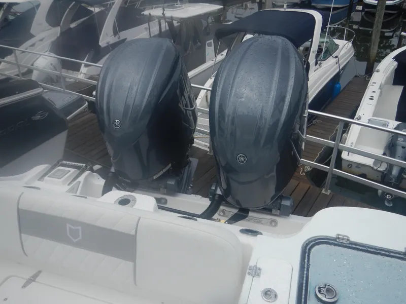 Slide: The Image of 2025 Sea Fox 268 Commander with twin outboard engines at a marina. - 6