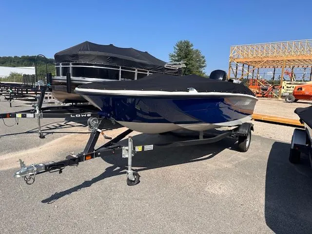 Slide: The Image of 2024 Bayliner E16LE boat on a trailer in a marina. - 1