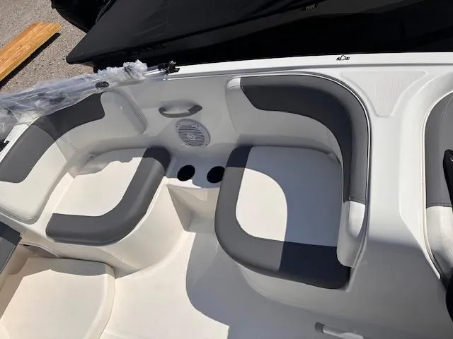 Slide: The Image of 2024 Bayliner E16LE boat interior seating with gray and white cushions. - 3