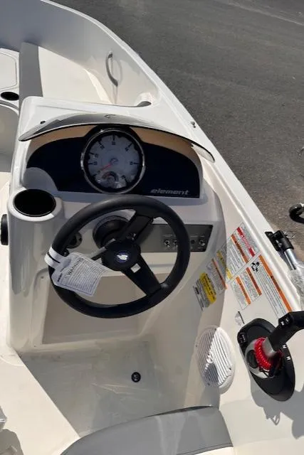 Slide: The Image of 2024 Bayliner E16LE boat dashboard with steering wheel and instrument panel. - 7