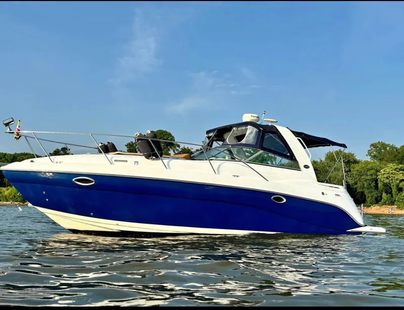 Slide: The Image of 2006 Rinker 320 Express Cruiser boat on calm water with clear blue sky. - 0