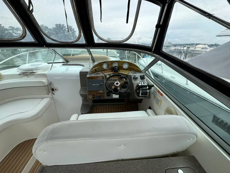 Slide: The Image of 2006 Rinker 320 Express Cruiser helm with steering wheel and navigation controls. - 12