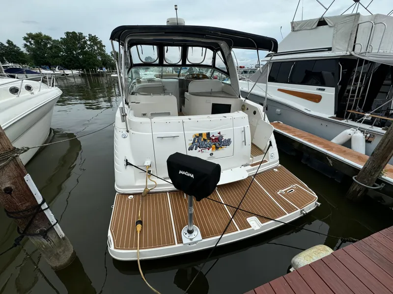 Slide: The Image of 2006 Rinker 320 Express Cruiser docked at a marina. - 3