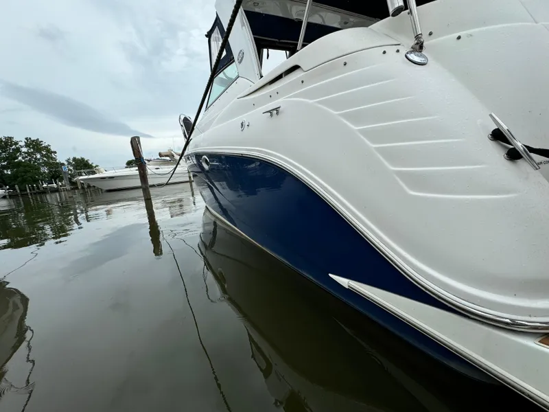 Slide: The Image of 2006 Rinker 320 Express Cruiser docked on calm water. - 5