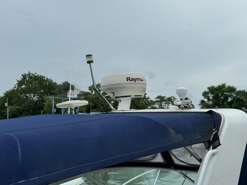 Slide: The Image of 2006 Rinker 320 Express Cruiser with Raymarine radar and blue canvas top. - 6