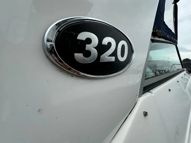 Slide: The Image of 2006 Rinker 320 Express Cruiser boat model emblem. - 7