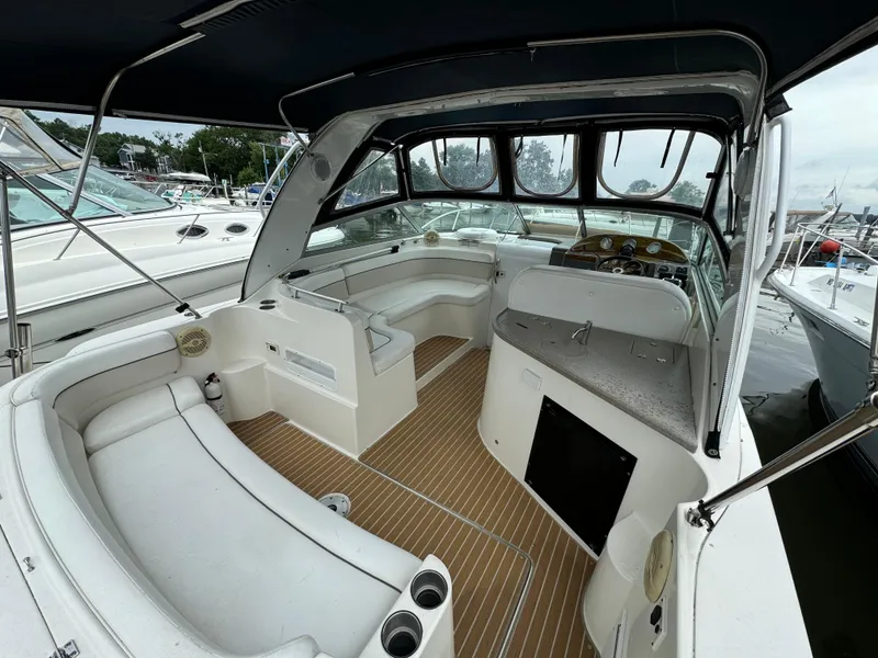 Slide: The Image of 2006 Rinker 320 Express Cruiser interior with seating and helm station. - 8