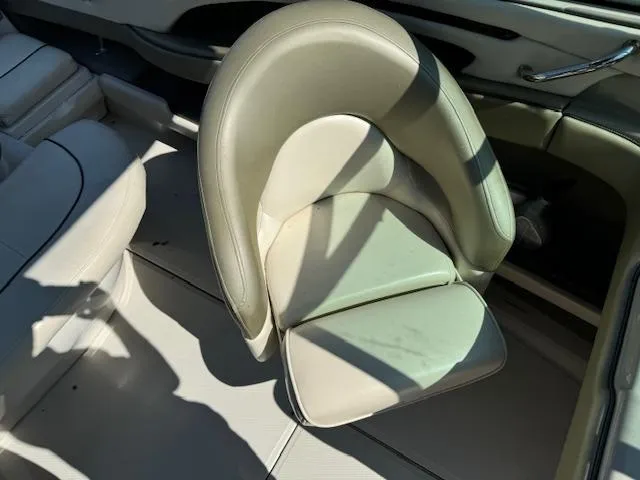 Slide: The Image of 2005 Sea Ray 200 Select boat interior with beige seating. - 12