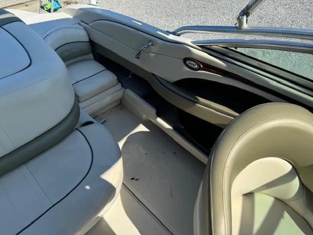 Slide: The Image of 2005 Sea Ray 200 Select boat interior with beige seating and dashboard. - 15