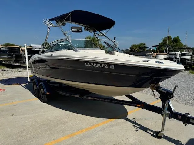 Slide: The Image of 2005 Sea Ray 200 Select boat on trailer with bimini top in marina. - 2