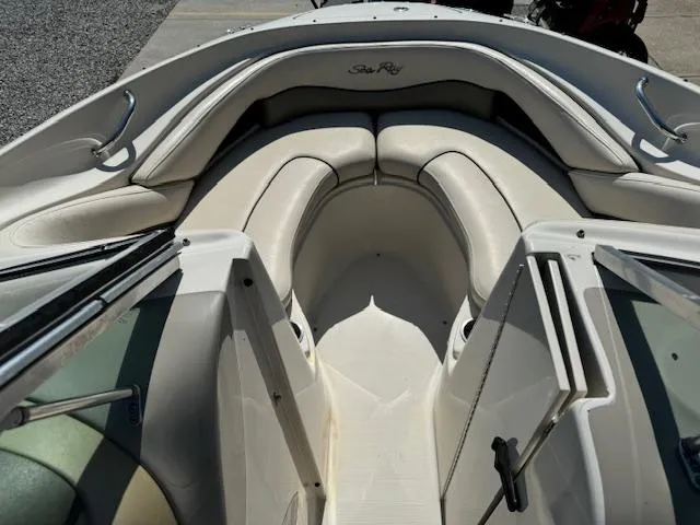 Slide: The Image of 2005 Sea Ray 200 Select boat interior with white cushioned seating. - 4