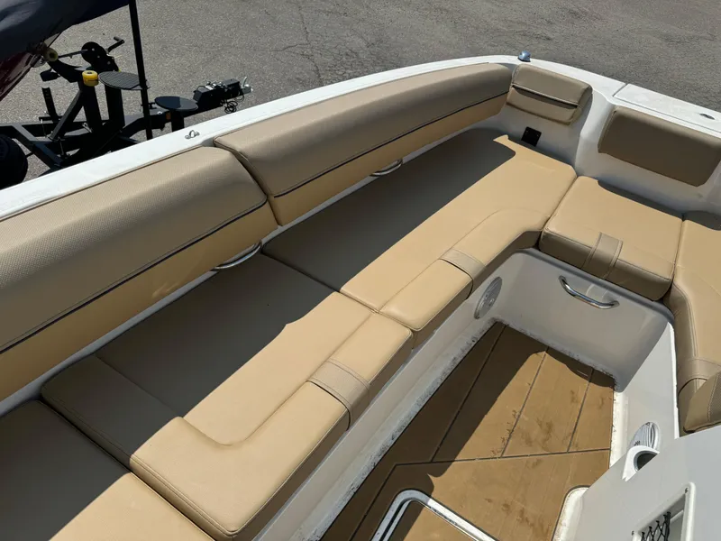 Slide: The Image of 2023 Bayliner DX 2000 boat storage compartment with open hatch and visible wiring. - 10