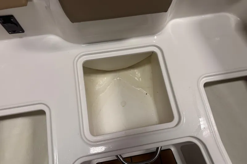 Slide: The Image of 2023 Bayliner DX 2000 boat interior storage compartment, white finish. - 18