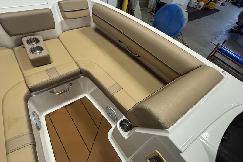 Slide: The Image of 2023 Bayliner DX 2000 boat interior with tan seating and cup holders. - 21