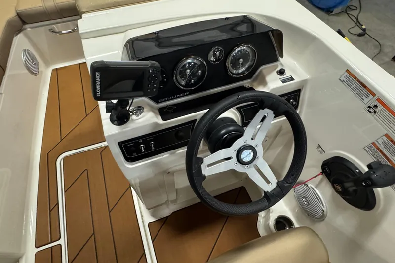 Slide: The Image of 2023 Bayliner DX 2000 boat dashboard with steering wheel and navigation system. - 25