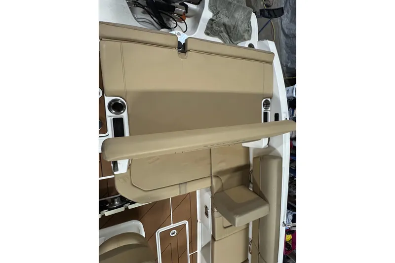 Slide: The Image of 2023 Bayliner DX 2000 boat interior with tan seating and cup holders. - 30