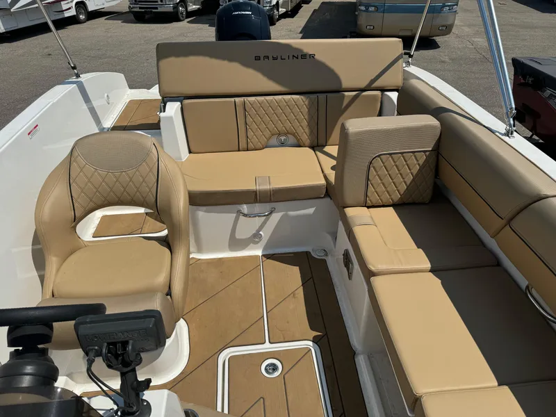 Slide: The Image of 2023 Bayliner DX 2000 boat interior with beige seating and diamond-patterned upholstery. - 5