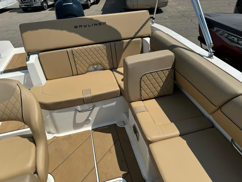 Slide: The Image of 2023 Bayliner DX 2000 boat interior with tan seating and diamond stitching. - 6