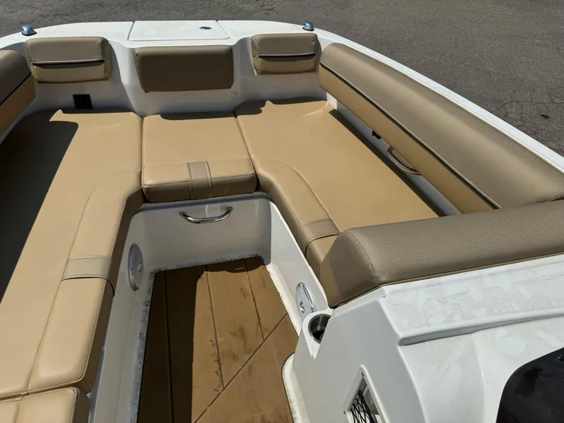 Slide: The Image of 2023 Bayliner DX 2000 boat interior with beige cushioned seating. - 7