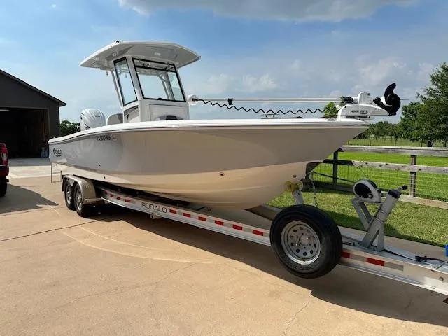 The Image of 2022 Robalo 266 Cayman boat on trailer in driveway. - 0