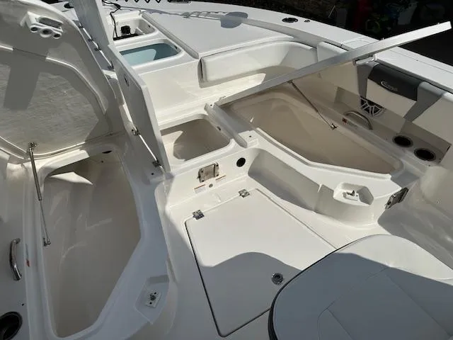 Slide: The Image of 2022 Robalo 266 Cayman boat interior storage compartments and seating area. - 12