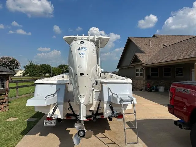 Slide: The Image of 2022 Robalo 266 Cayman boat with 425 HP engine parked in driveway. - 5