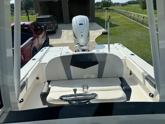 Slide: The Image of 2022 Robalo 266 Cayman boat with outboard motor, parked in driveway. - 6