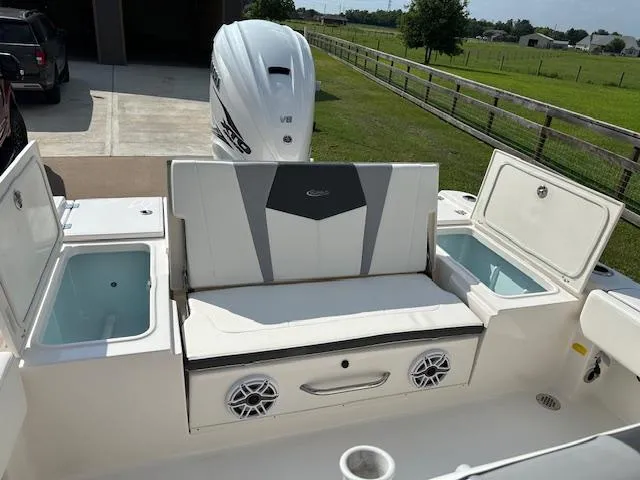 Slide: The Image of 2022 Robalo 266 Cayman boat with seating and storage compartments. - 8