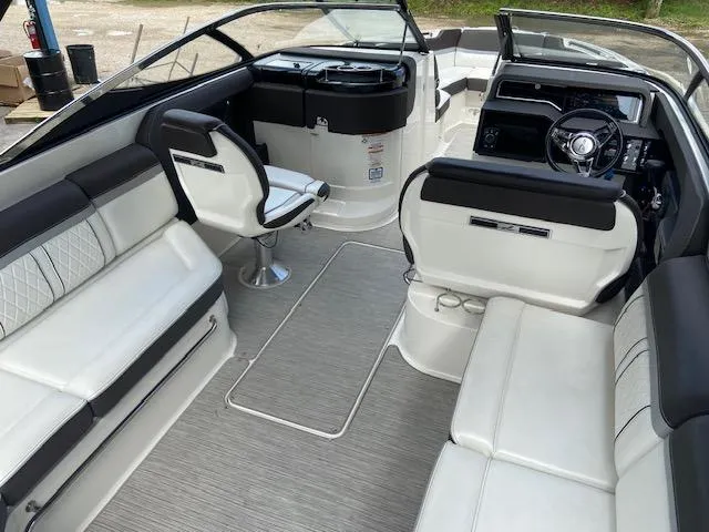 Slide: The Image of 2017 Sea Ray 280 SLX boat interior with white and black seating, steering console, and open layout. - 10