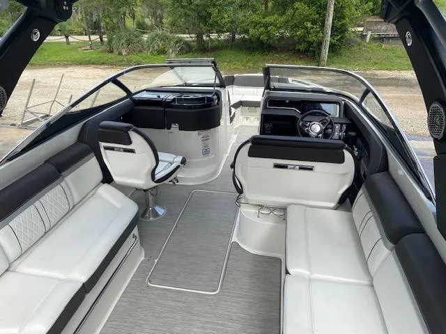 Slide: The Image of 2017 Sea Ray 280 SLX boat interior with white and black seating, steering console, and open deck. - 11
