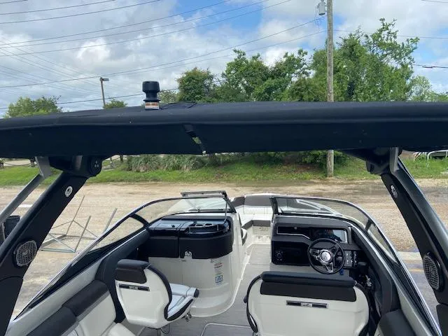 Slide: The Image of 2017 Sea Ray 280 SLX boat interior with black canopy and white seating. - 12