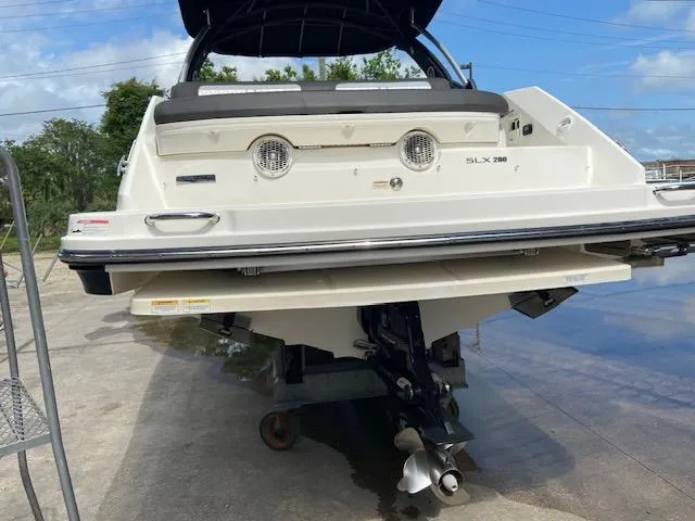 Slide: The Image of 2017 Sea Ray 280 SLX boat stern view on a trailer. - 6