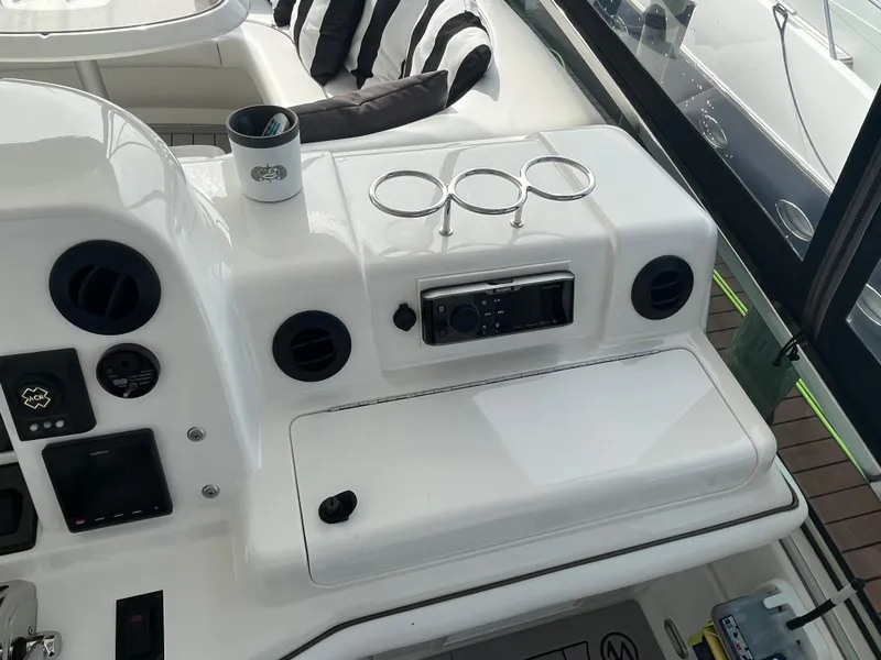Slide: The Image of Control panel of a 2007 Sea Ray 52 Sedan Bridge yacht with cup holders. - 18