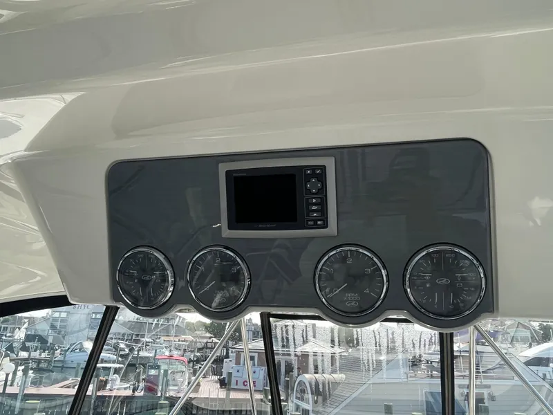 Slide: The Image of Dashboard of a 2007 Sea Ray 52 Sedan Bridge yacht with gauges and a display. - 19