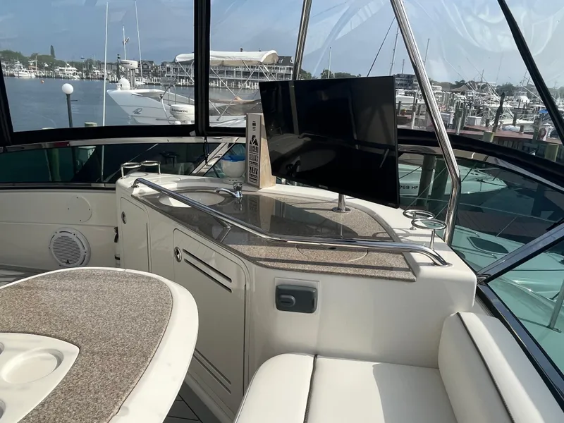 Slide: The Image of 2007 Sea Ray 52 Sedan Bridge yacht interior with TV and seating area. - 22