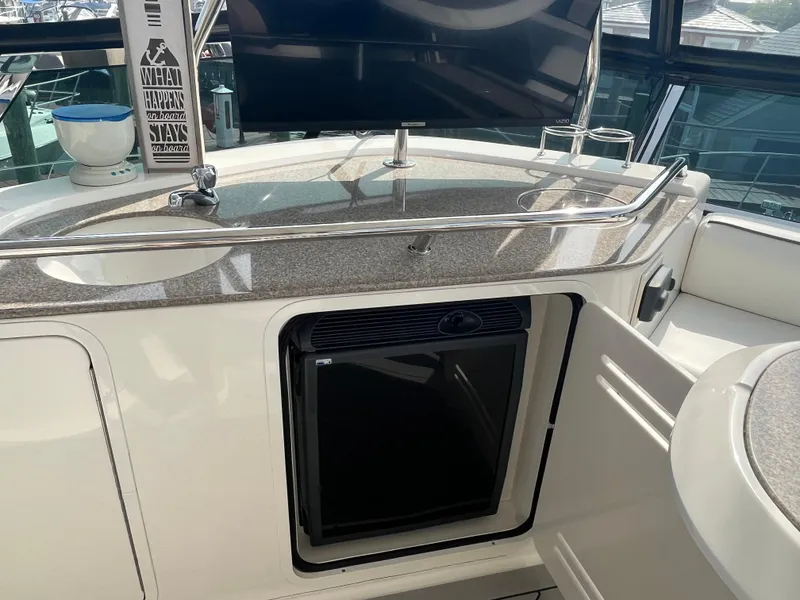 Slide: The Image of 2007 Sea Ray 52 Sedan Bridge yacht interior with mini fridge and sink. - 23