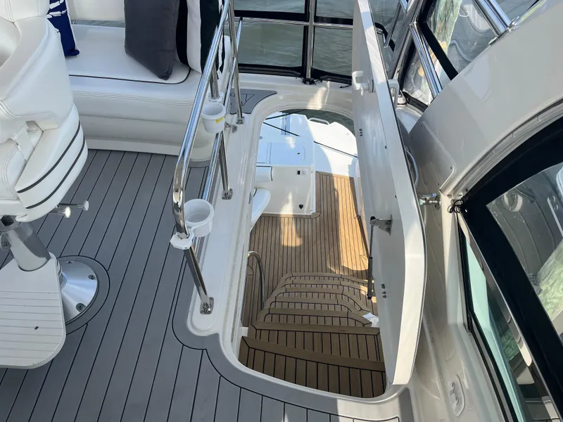 Slide: The Image of 2007 Sea Ray 52 Sedan Bridge yacht interior with stairs and seating area. - 25