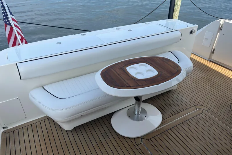 Slide: The Image of 2007 Sea Ray 52 Sedan Bridge yacht deck with seating and table. - 29