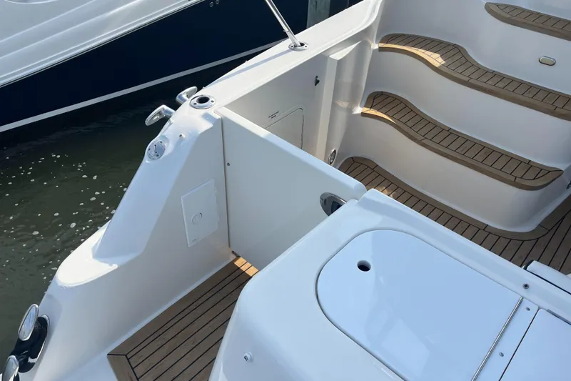 Slide: The Image of 2007 Sea Ray 52 Sedan Bridge boat deck with teak steps and white fixtures. - 32