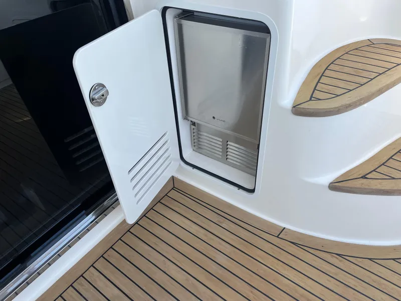 Slide: The Image of 2007 Sea Ray 52 Sedan Bridge yacht with open storage compartment and wooden deck. - 38