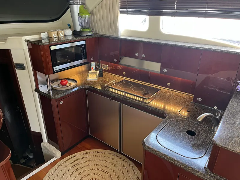 Slide: The Image of Modern kitchen in 2007 Sea Ray 52 Sedan Bridge yacht with microwave, stove, and sink. - 4