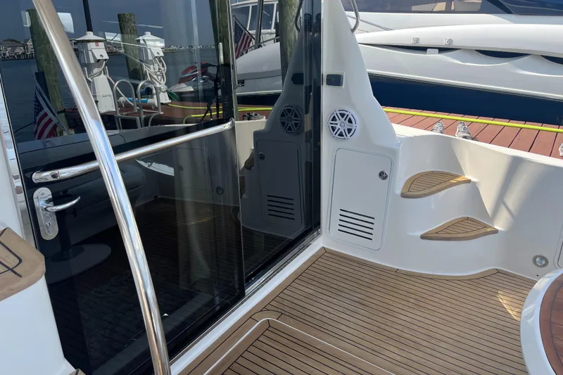 Slide: The Image of 2007 Sea Ray 52 Sedan Bridge yacht deck with sliding glass door and wooden flooring. - 42