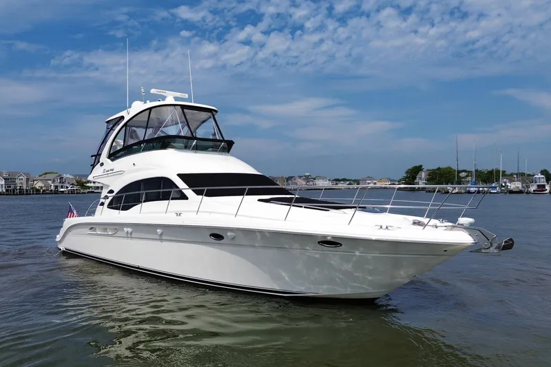 Slide: The Image of 2007 Sea Ray 52 Sedan Bridge yacht on calm water with a clear sky. - 5
