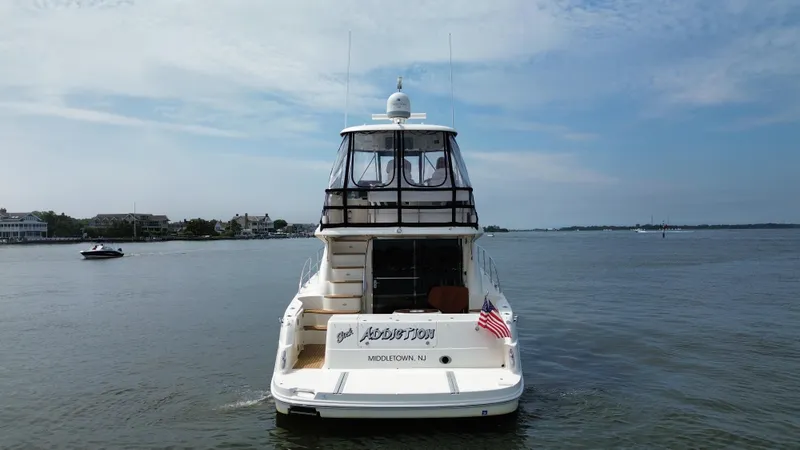 Slide: The Image of 2007 Sea Ray 52 Sedan Bridge yacht on calm water. - 8