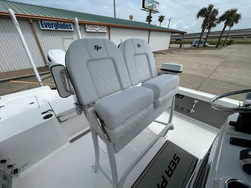 Slide: The Image of 2024 Sea Pro 250 DLX boat with dual captain's chairs and diamond-stitched upholstery. - 18