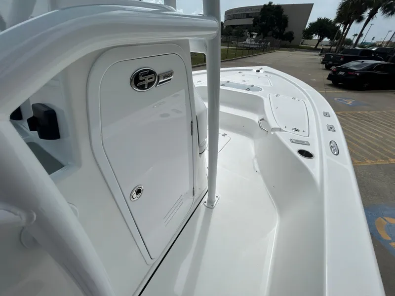 Slide: The Image of 2024 Sea Pro 250 DLX boat deck, white finish, docked in a parking lot. - 20