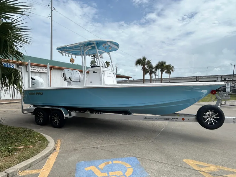 Slide: The Image of 2024 Sea Pro 250 DLX boat on trailer, parked in a marina lot. - 5