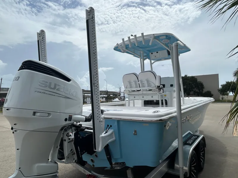 Slide: The Image of 2024 Sea Pro 250 DLX boat with Suzuki outboard motor, docked on a trailer. - 6